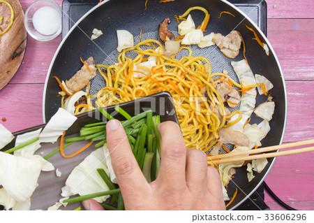 Chef put slicing of spring onion for cooking Chef put slicing of spring onion for cooking 33606296