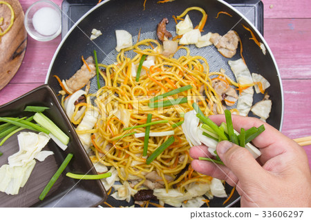 Chef put slicing of spring onion for cooking Chef put slicing of spring onion for cooking 33606297