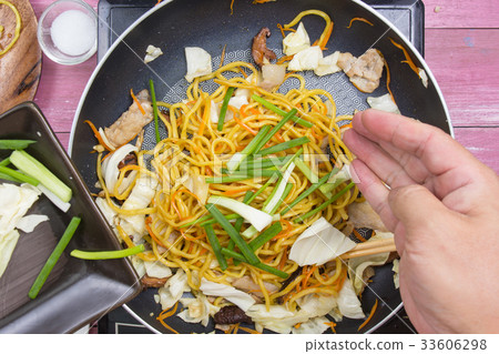 Chef put slicing of spring onion for cooking 33606298