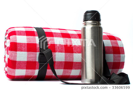 Picnic blanket and a thermos isolated 33606599