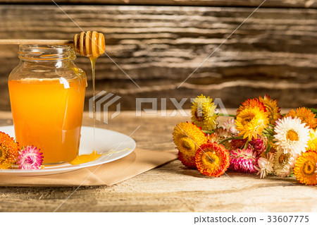The bowl with honey on wooden table.The bank of 33607775