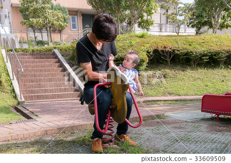 Parent and child playing in the park Parent and child playing in the park 33609509