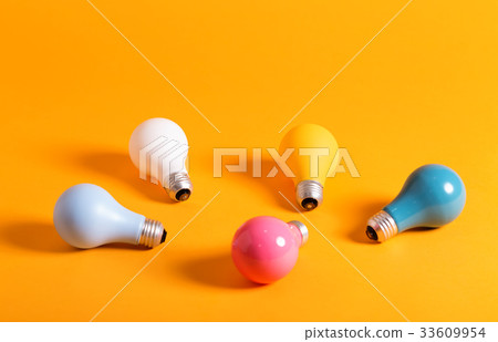 Colored light bulbs on a yellow background Colored light bulbs on a yellow background 33609954