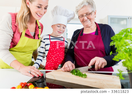 Granny showing old family recipe to grandson and 33611823