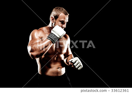 Sportsman muay thai boxer fighting in boxing cage. Isolated on b 33612361