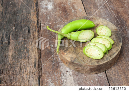 Fresh Eggplants, one cut in slices on a wooden 33612850