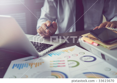 man hand working smart phone on wooden desk man hand working smart phone on wooden desk 33615670