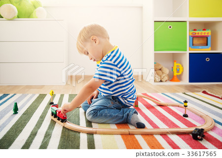 Little child playing with railroad Little child playing with railroad 33617565