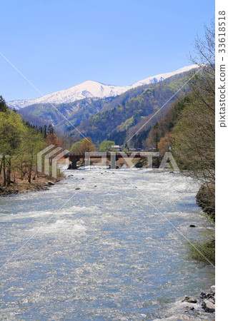 Inan River in spring and mountains with residual snow (Minami Aizu Town) 33618518