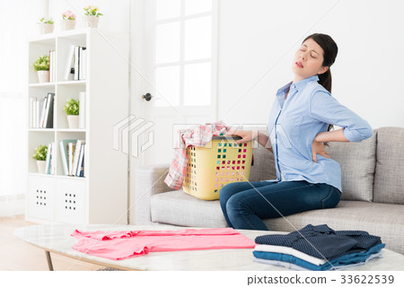 pretty young woman sitting on sofa stretching body pretty young woman sitting on sofa stretching body 33622539