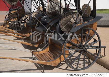 Many old carts parked on the street. 33622792