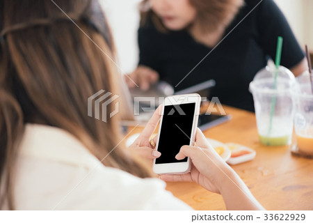 Close up of Asian women's hands holding phone. 33622929