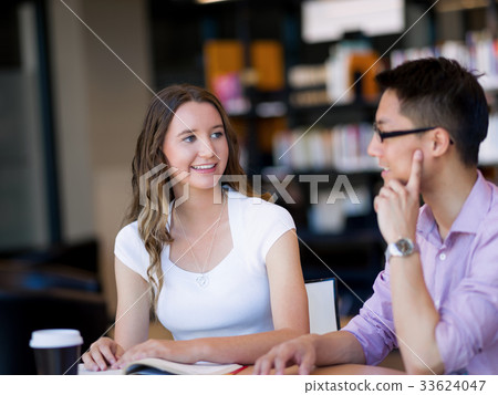 Two young students at the library 33624047