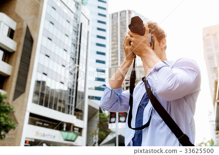 Male photographer taking picture Male photographer taking picture 33625500
