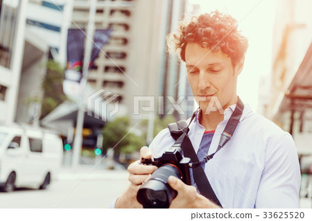 Male photographer taking picture 33625520