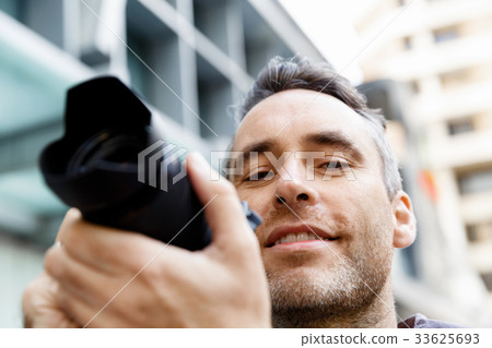 Male photographer taking picture Male photographer taking picture 33625693