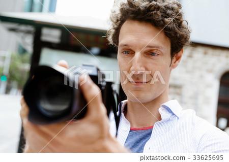 Male photographer taking picture Male photographer taking picture 33625695