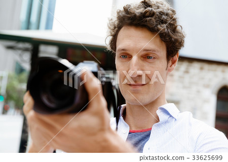 Male photographer taking picture Male photographer taking picture 33625699