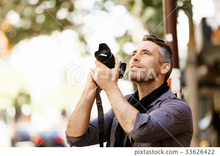 Male photographer taking picture Male photographer taking picture 33626422