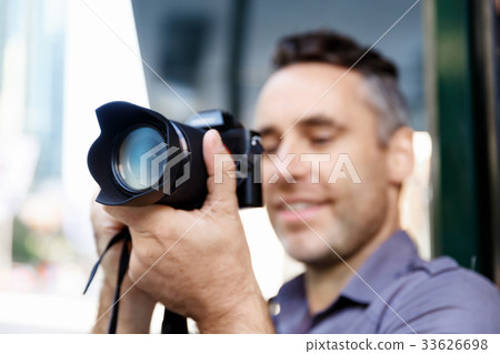 Male photographer taking picture 33626698