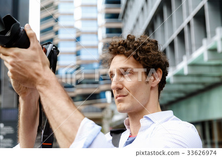 Male photographer taking picture 33626974