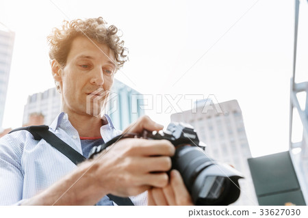 Male photographer taking picture Male photographer taking picture 33627030