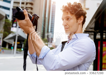 Male photographer taking picture 33627280