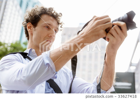 Male photographer taking picture 33627418