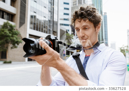 Male photographer taking picture Male photographer taking picture 33627528