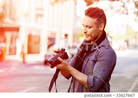 Male photographer taking picture 33627667