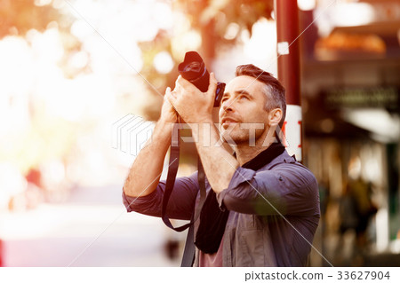 Male photographer taking picture 33627904