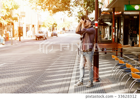 Male photographer taking picture 33628312