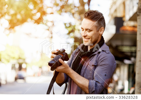 Male photographer taking picture Male photographer taking picture 33628328
