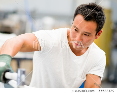 Asian worker in production plant on the factory floor Asian worker in production plant on the factory floor 33628329