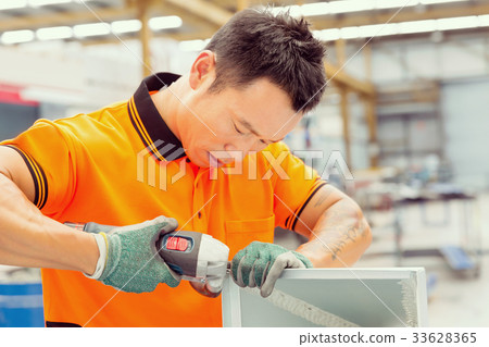 Asian worker in production plant on the factory floor 33628365