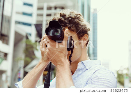 Male photographer taking picture Male photographer taking picture 33628475