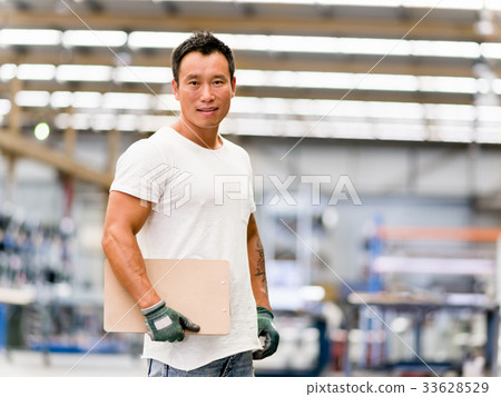 Asian worker in production plant on the factory floor 33628529