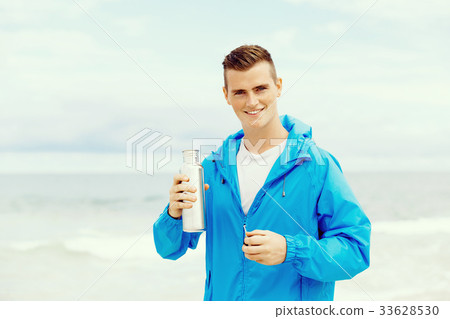 Man drinking from a sports bottle Man drinking from a sports bottle 33628530