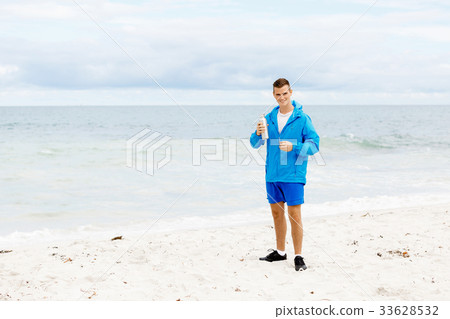 Confident young man holding bottle with water 33628532