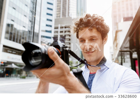 Male photographer taking picture 33628600