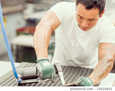 Asian worker in production plant on the factory floor Asian worker in production plant on the factory floor 33628602