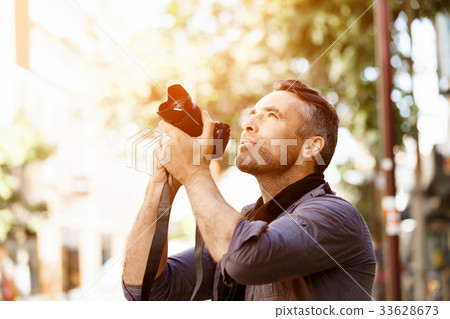 Male photographer taking picture Male photographer taking picture 33628673