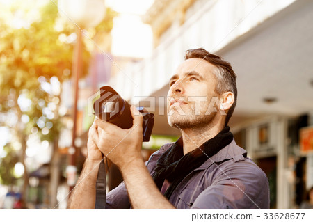 Male photographer taking picture 33628677