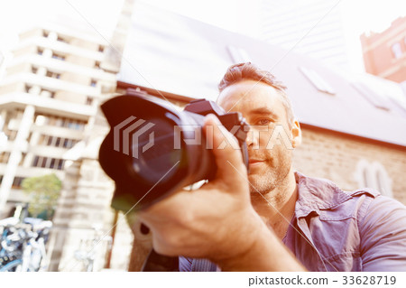 Male photographer taking picture Male photographer taking picture 33628719