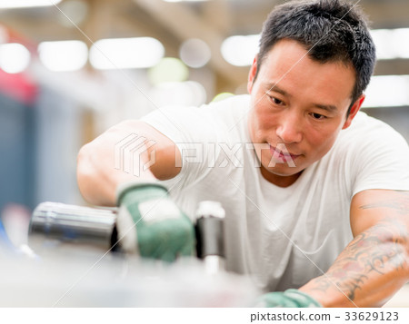 Asian worker in production plant on the factory floor 33629123