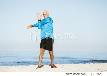Man training on beach outside 33629210