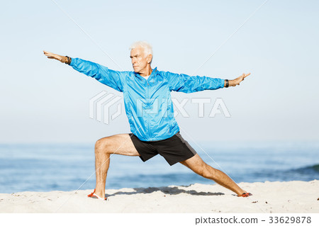 Man training on beach outside Man training on beach outside 33629878