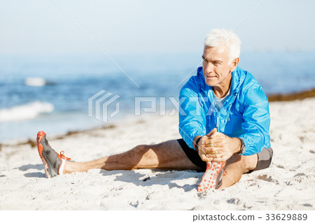 Man training on beach outside 33629889