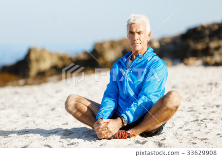 Man training on beach outside Man training on beach outside 33629908