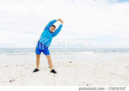Man training on beach outside Man training on beach outside 33630197